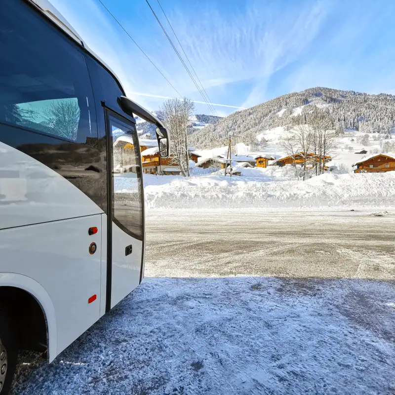 A transfer coach in a ski resort, taking skiers and snowboarders from the airport to their winter holiday. Airport transfers to ski resorts across europe.