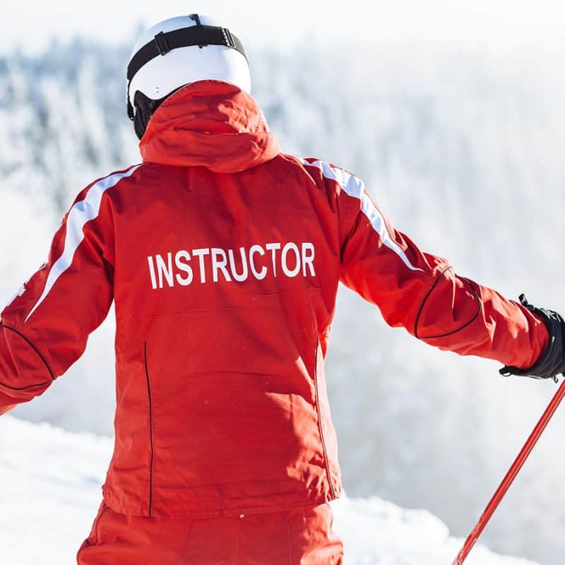 Ski Instructor on the slopes giving group or private ski lessons